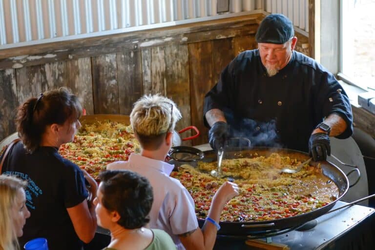 Chef serving guests at Rockin H Ranch, featuring event catering vendors for a ranch wedding near Palm Beach Gardens.