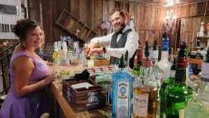 Bartender serving drinks at Rockin H Ranch, showcasing event vendor hospitality at a ranch wedding near Palm Beach Gardens.