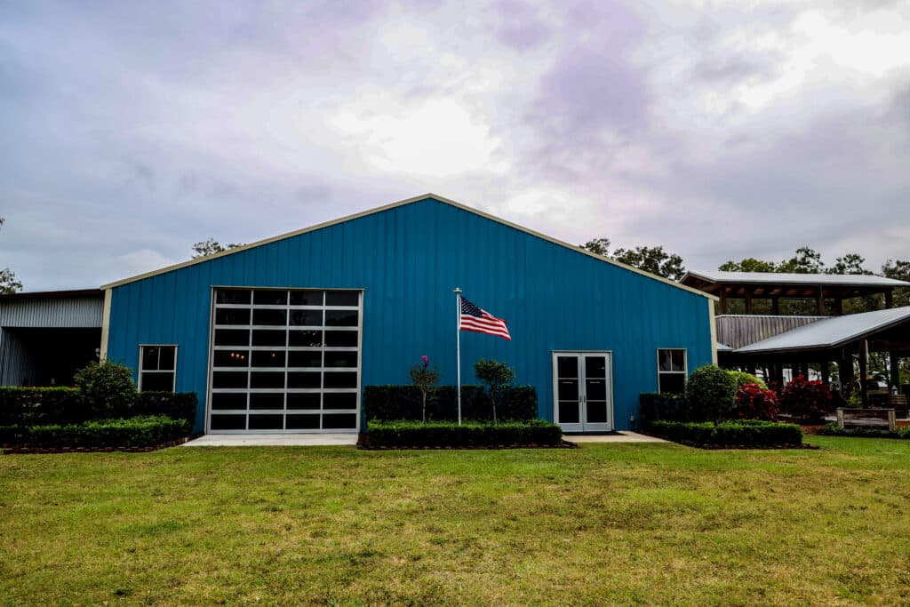 Exterior view of the iconic blue barn at Rockin H Ranch, one of the top wedding venues near Palm Beach, showcasing its rustic charm and spacious design. Perfect for hosting unforgettable celebrations in South Florida.