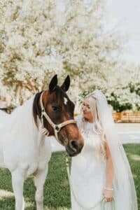 Bride Petting a horse at her Palm Beach wedding