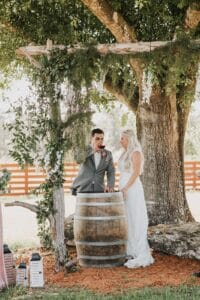 Bride Petting a horse at her Palm Beach wedding
