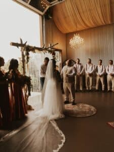 Indoor ceremony at a Palm Beach wedding venue with bride and groom exchanging vows